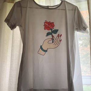 Large, shirt hand holding a rose.